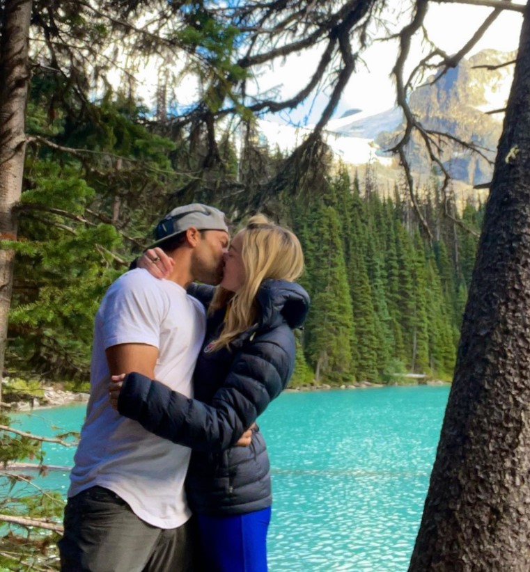 Caity Lotz kissing her boyfriend Kyle Schmid.