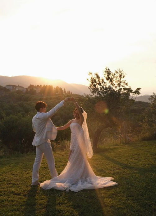 Kimberley Woltemas and fiance Mark Prin posing in front of sunset in Italy.