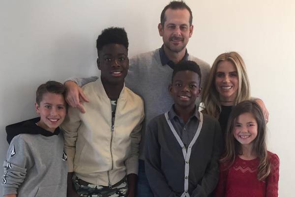 Laura Cover with her husband, Aaron Boone, and their four children