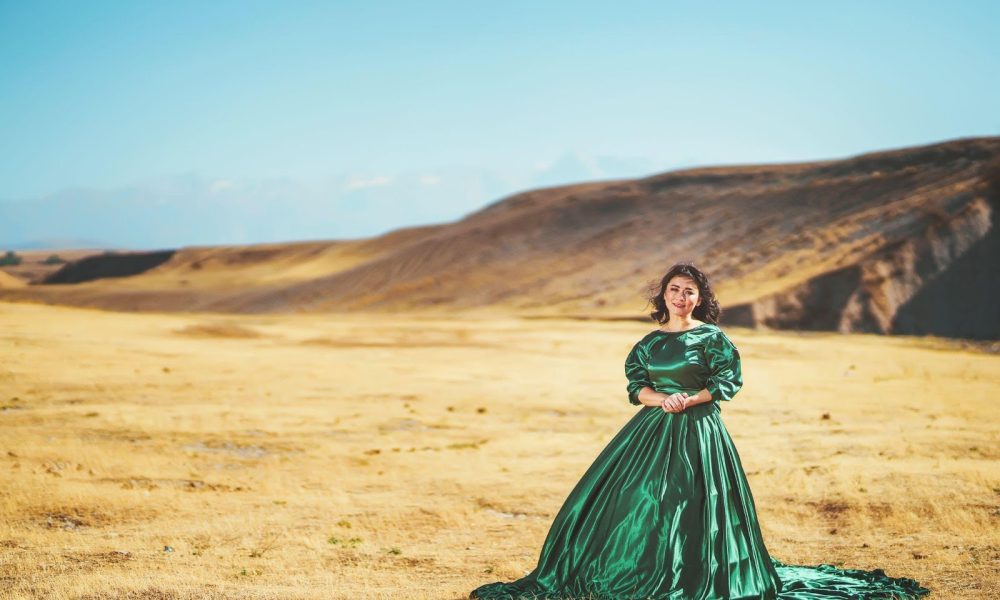woman wearing green gown near mountain