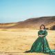 woman wearing green gown near mountain