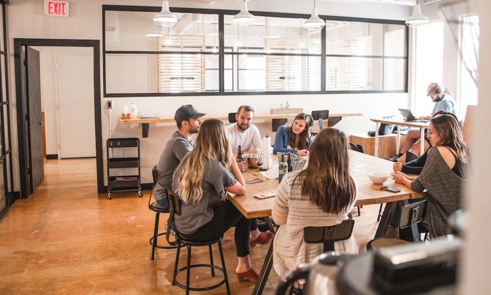 A team meeting where they discuss a self-service knowledge base.
