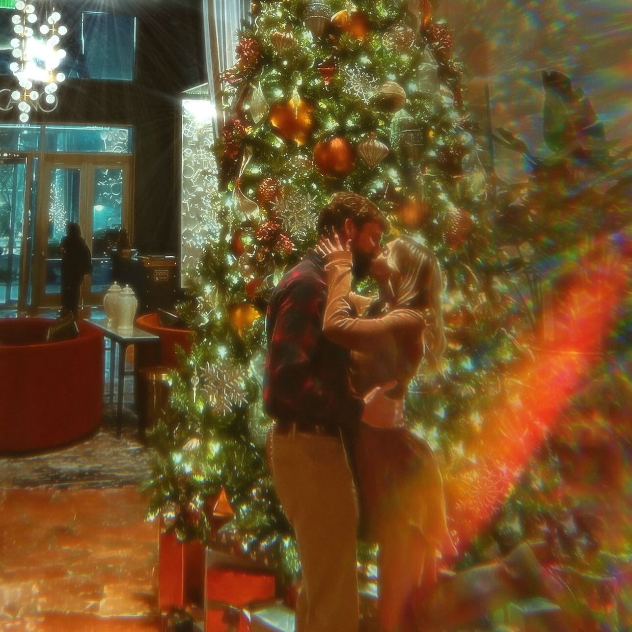 Lindsie Chrisley kissing her ex-boyfriend Trent in front of a Christmas Tree in Atlanta