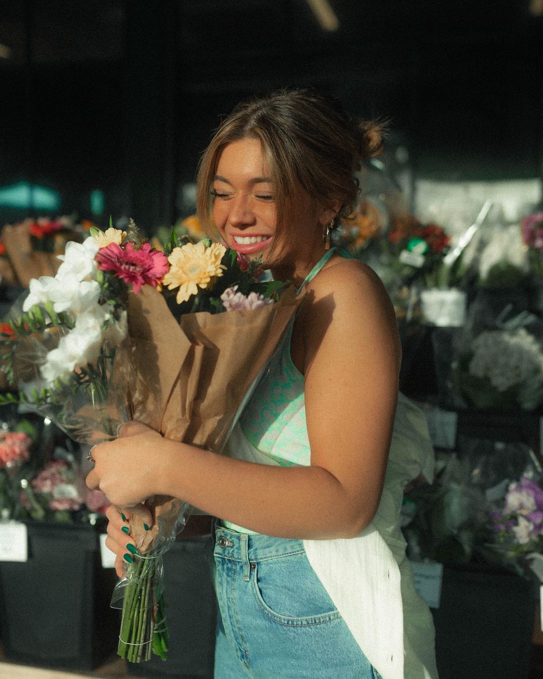 Tabitha Swatosh holding a flower bouquet.