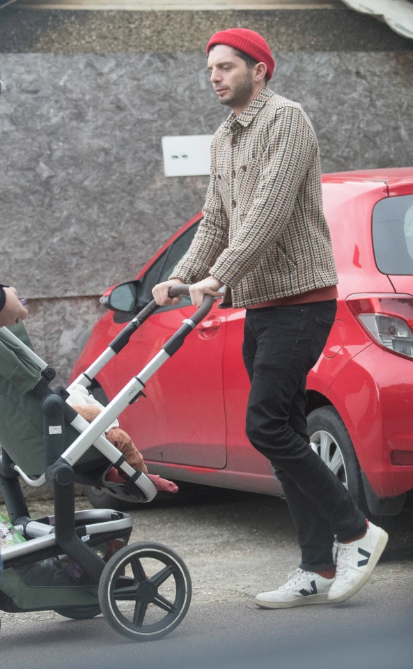 Laura Carmichael's boyfriend, Michael C. Fox, taking their son Luca on a stroll in a pushchair
