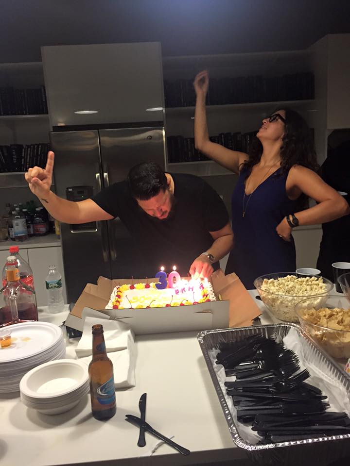Sal Vulcano decorating a cake as his wife Francesca Muffaletto stands beside him