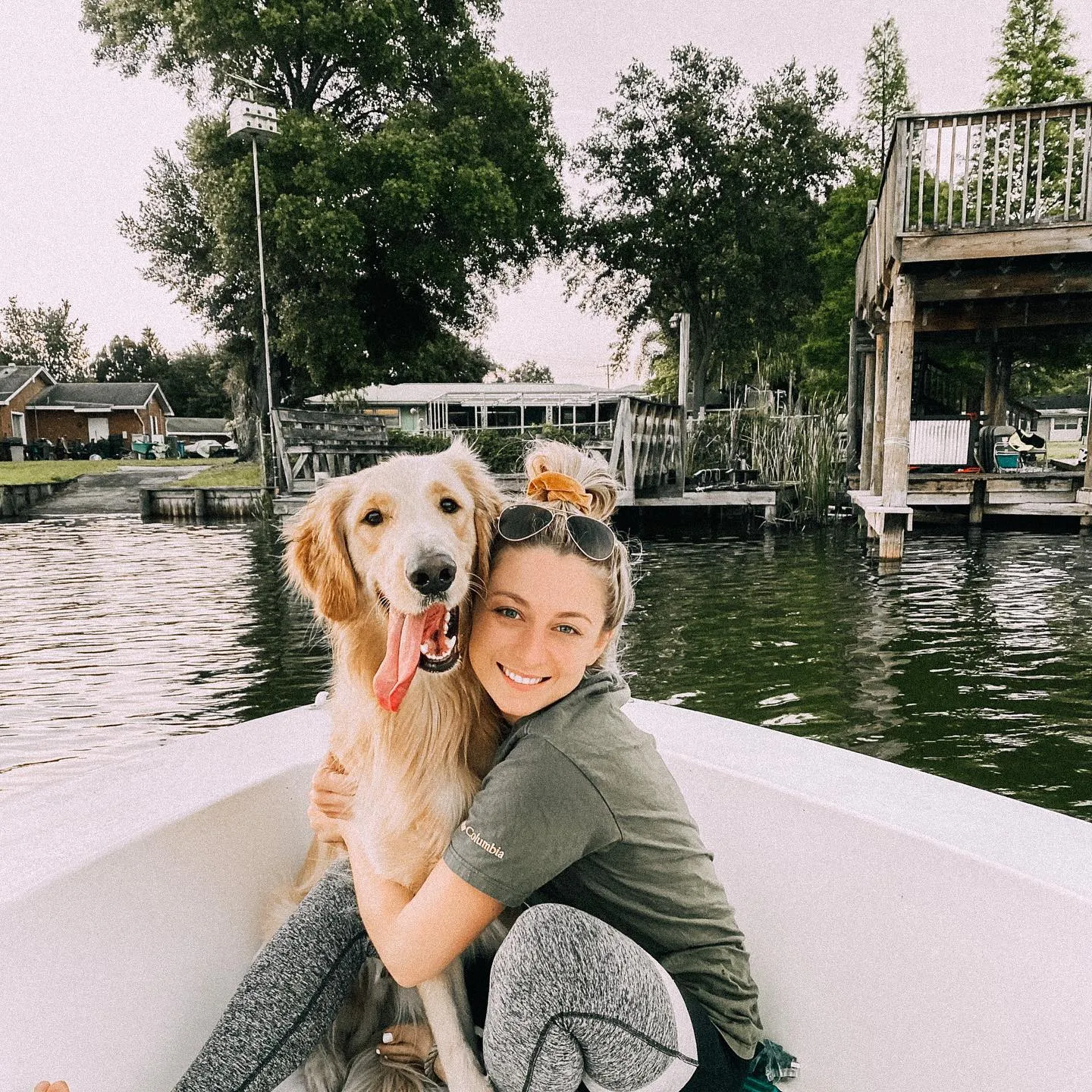 Tia Borso alongside her pet in a boat