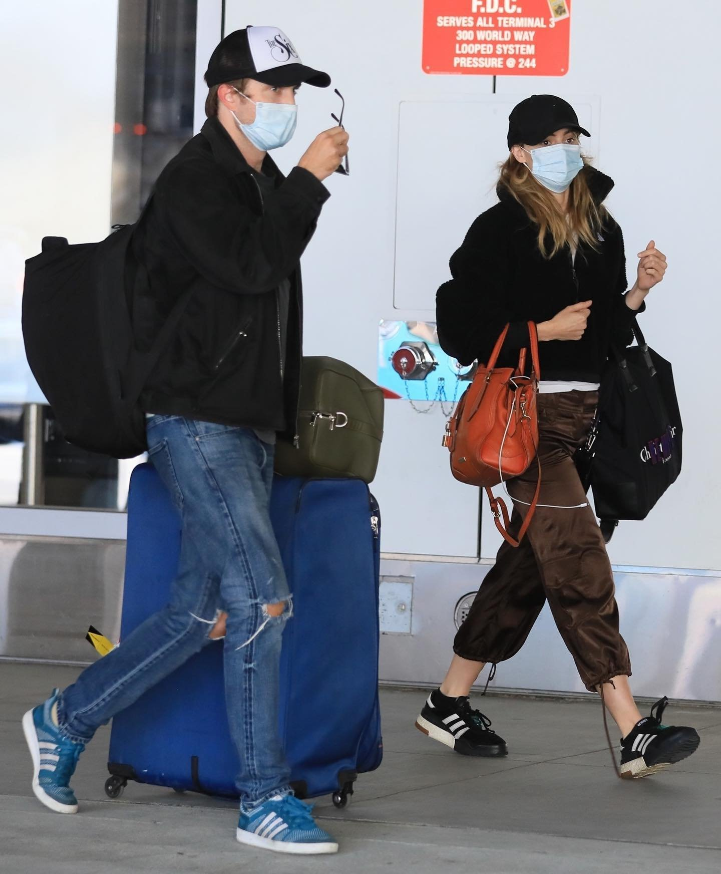 Robert Pattinson with Suki Waterhouse at airport. 