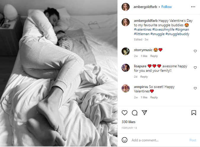 Amber Goldfarb posted her husband's photo snuggling with their child 