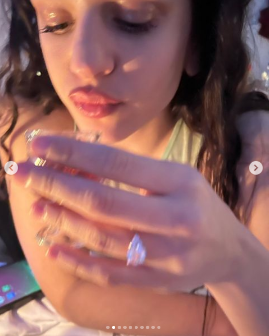 Rosalia showing off her bright diamond on her ring finger. 