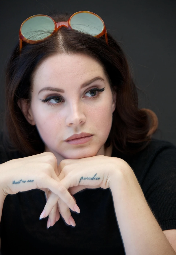 Lana Del Rey's "trust no one" and "paradise" tattoos. 