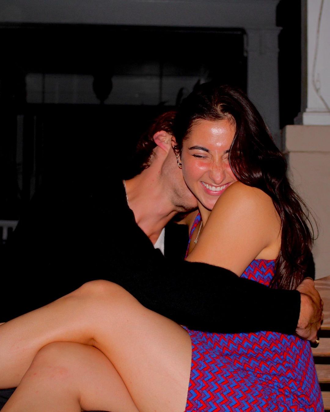 Christopher Briney kissing his girlfriend Isabel Machado