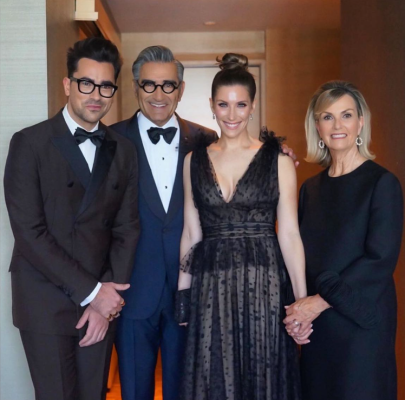 Dan Levy with his family posing for a picture