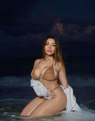 Katiana Kay poses wearing a beautiful bikini against a stunning location