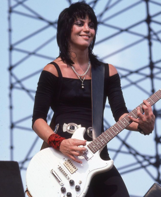 Joan Jett holding the guitar while performing on the stage