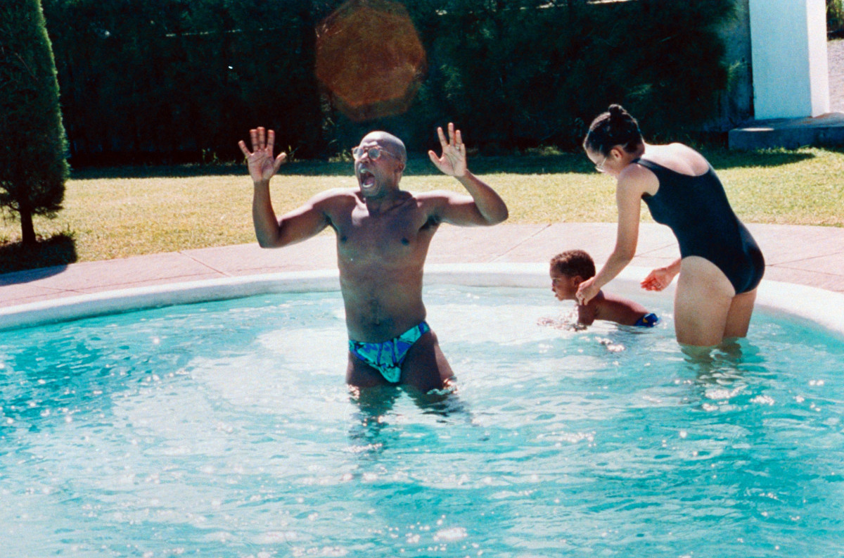 An old picture of Andre Braugher playing in a pool with his wife and eldest son Michael Braugher