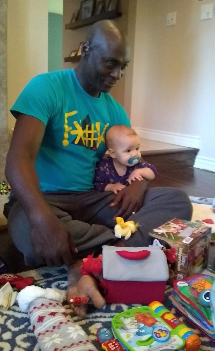 Lance Reddick with one of his two children