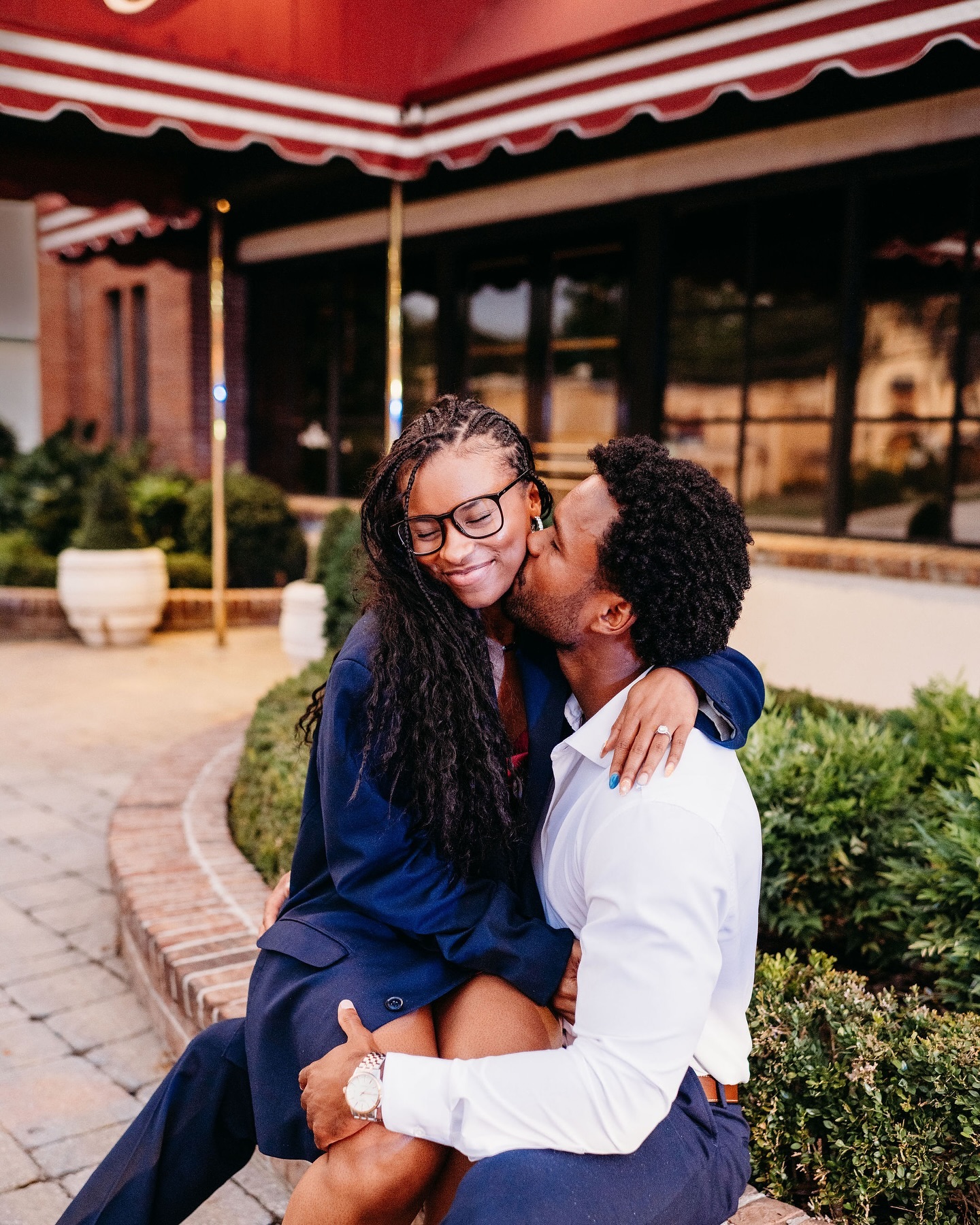 Aly Jacobs being kissed on the cheeks by her boyfriend following their engagement