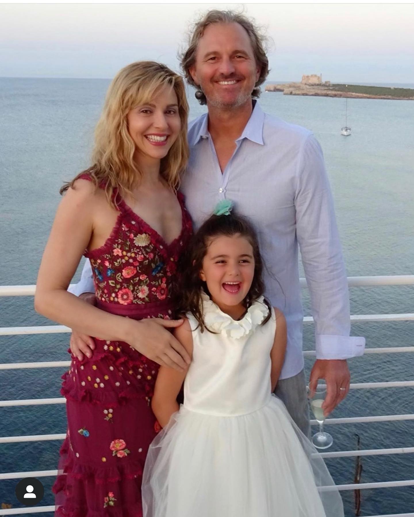 Cara Buono and her husband, Peter Thum, with their daughter in Italy