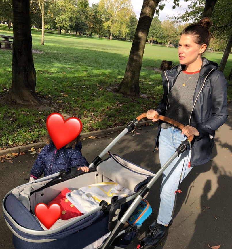 Henry Lloyd-Hughes's wife, Rosie Swash, with their two children in a park